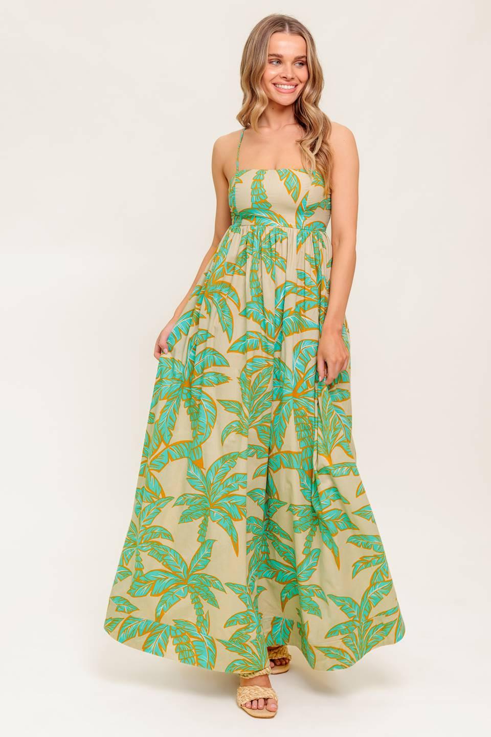 A printed woven maxi dress featuring straight neckline, straps, full skirt and bare back with smocking and tie closure.
