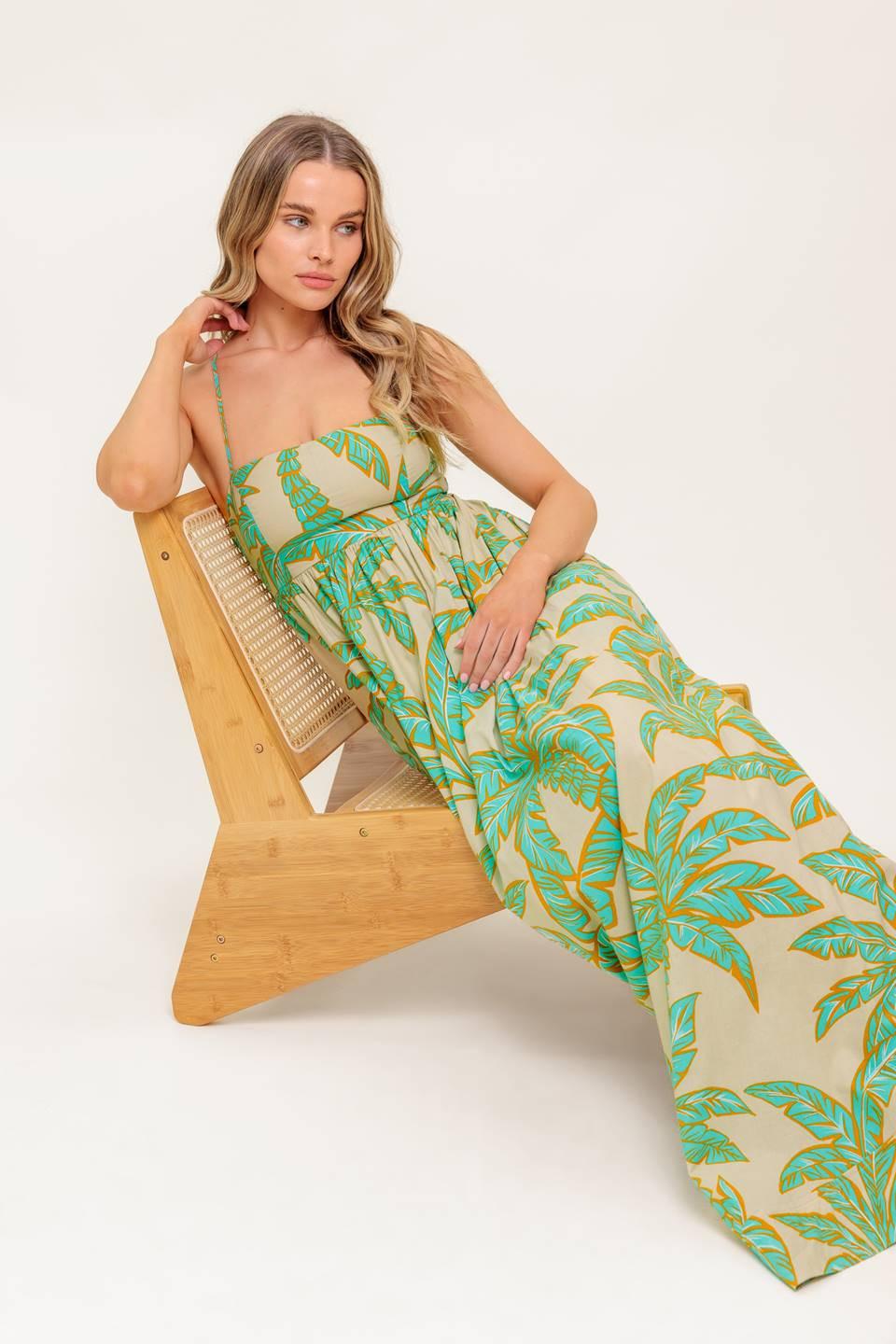 A printed woven maxi dress featuring straight neckline, straps, full skirt and bare back with smocking and tie closure.
