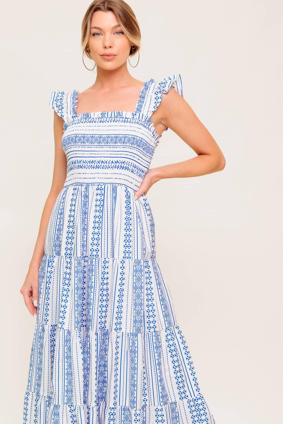 A printed woven midi dress featuring square neckline, ruffled sleeve, smocked bodice and tiered skirt.