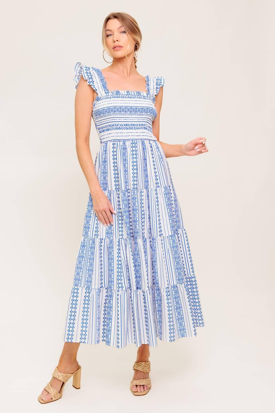 A printed woven midi dress featuring square neckline, ruffled sleeve, smocked bodice and tiered skirt.