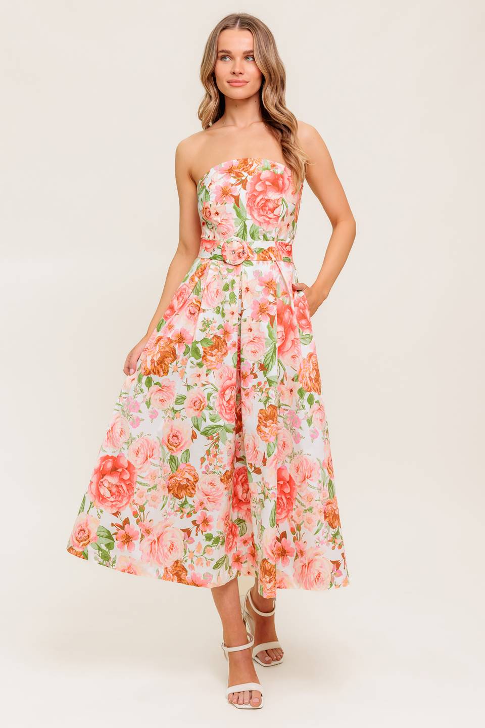 A printed woven midi dress featuring straight neckline, self belt, pleated full skirt and back zipper closure.