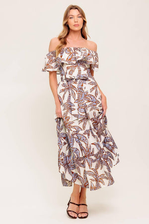 A printed woven midi dress featuring off shoulder neckline, flounce, elasticized waist with self sash tie and tiered skirt.