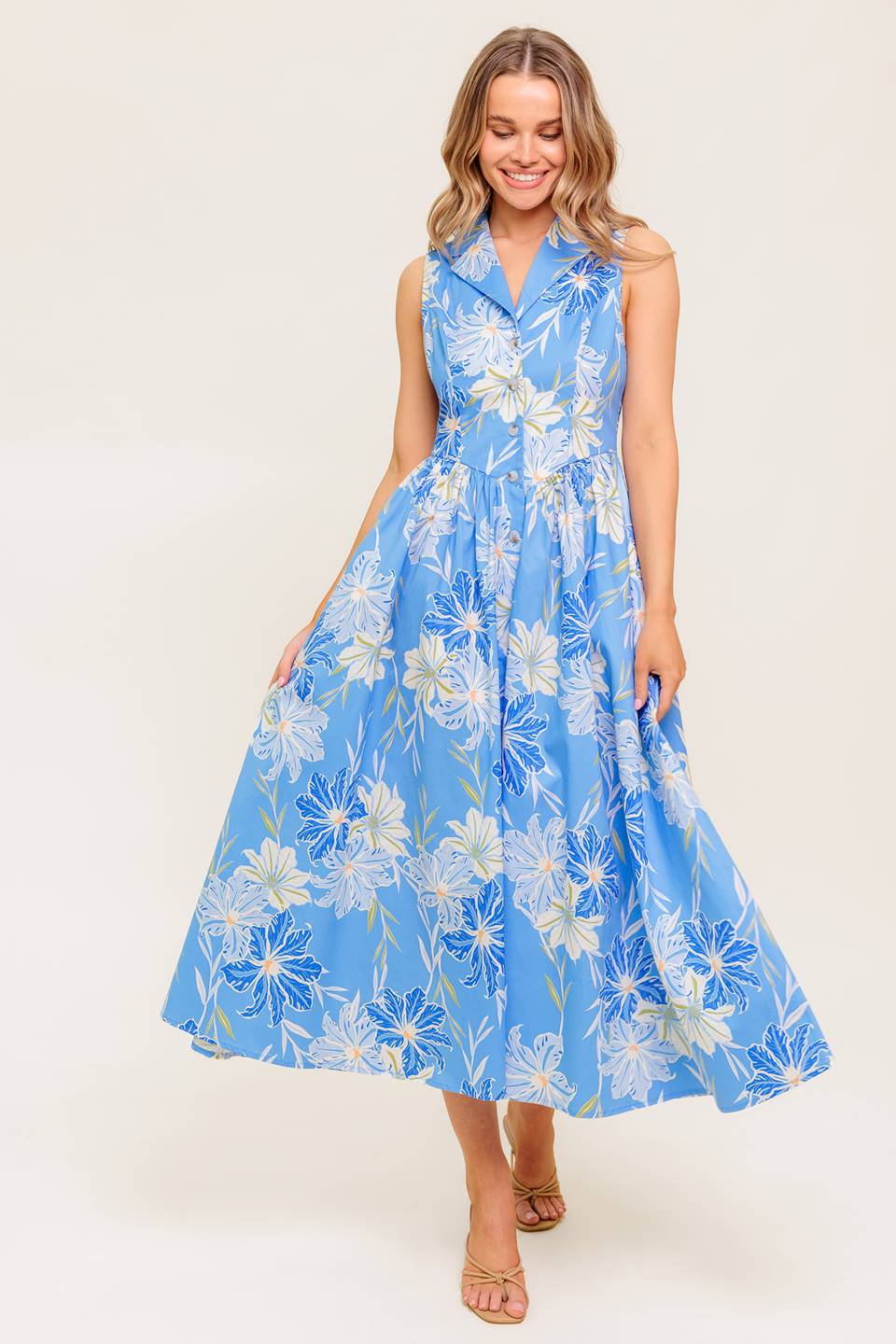 A printed woven midi dress featuring collar, sleeveless, basque waistline and button down closure.