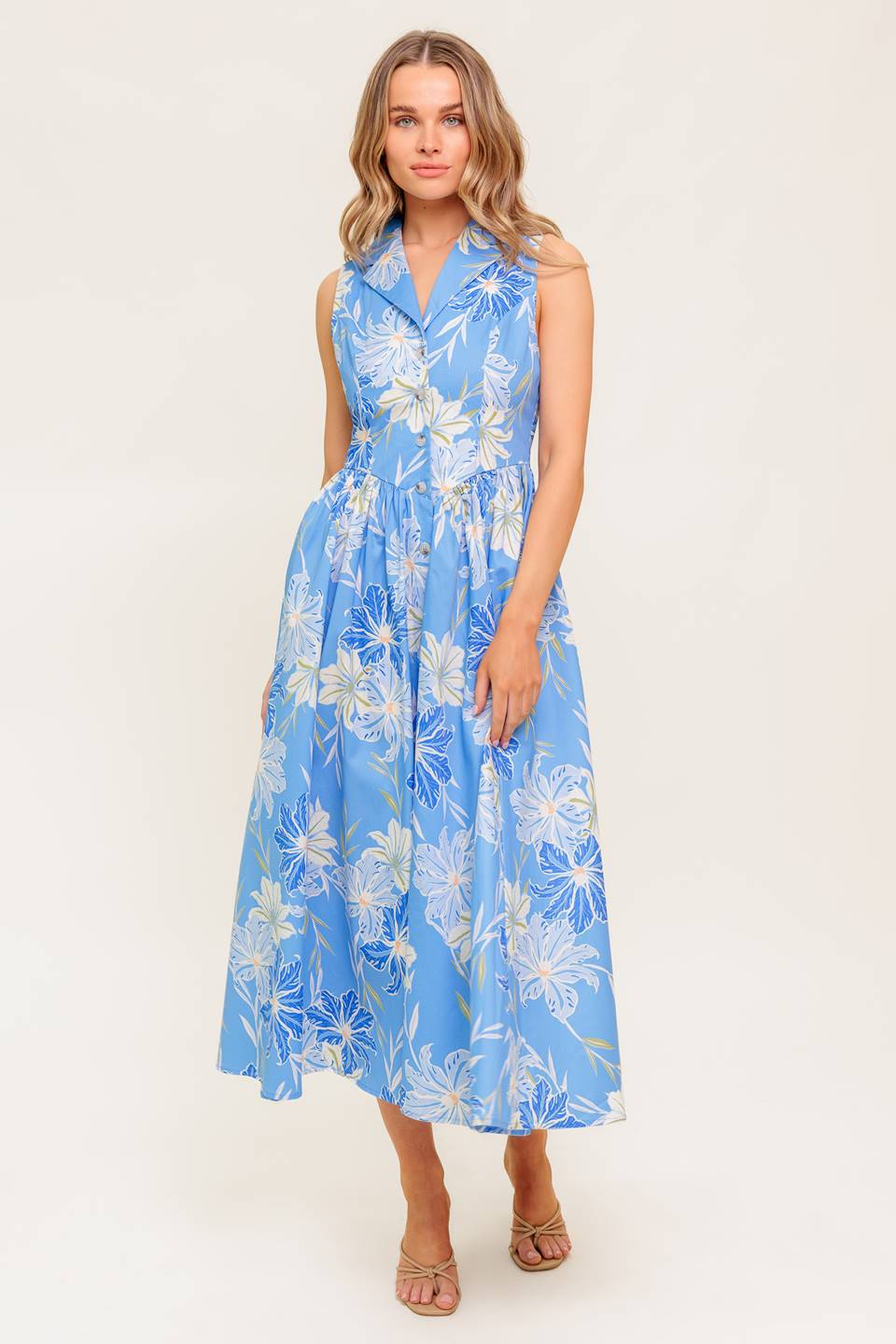 A printed woven midi dress featuring collar, sleeveless, basque waistline and button down closure.