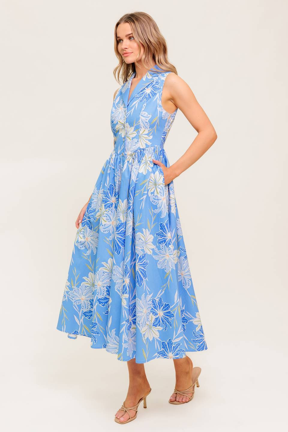 A printed woven midi dress featuring collar, sleeveless, basque waistline and button down closure.