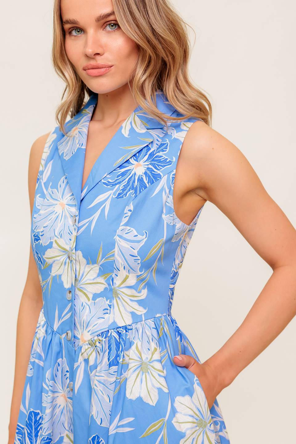 A printed woven midi dress featuring collar, sleeveless, basque waistline and button down closure.