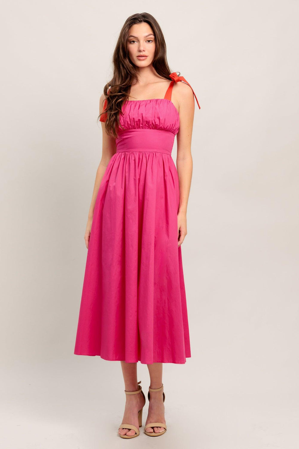 A solid fuchsia woven midi dress featuring straight neckline, red self-tie straps, shirred bodice, full skirt and smocked back bodice and zipper closure

Details:

Self : 100% Cotton
Contrast : 100% Cotton
Lining : 100% Cotton

Size &amp; Fit

- Model is 5`8" And Wearing Size Small
- Measurements Taken From Size Small
- Approx. Length: 51"