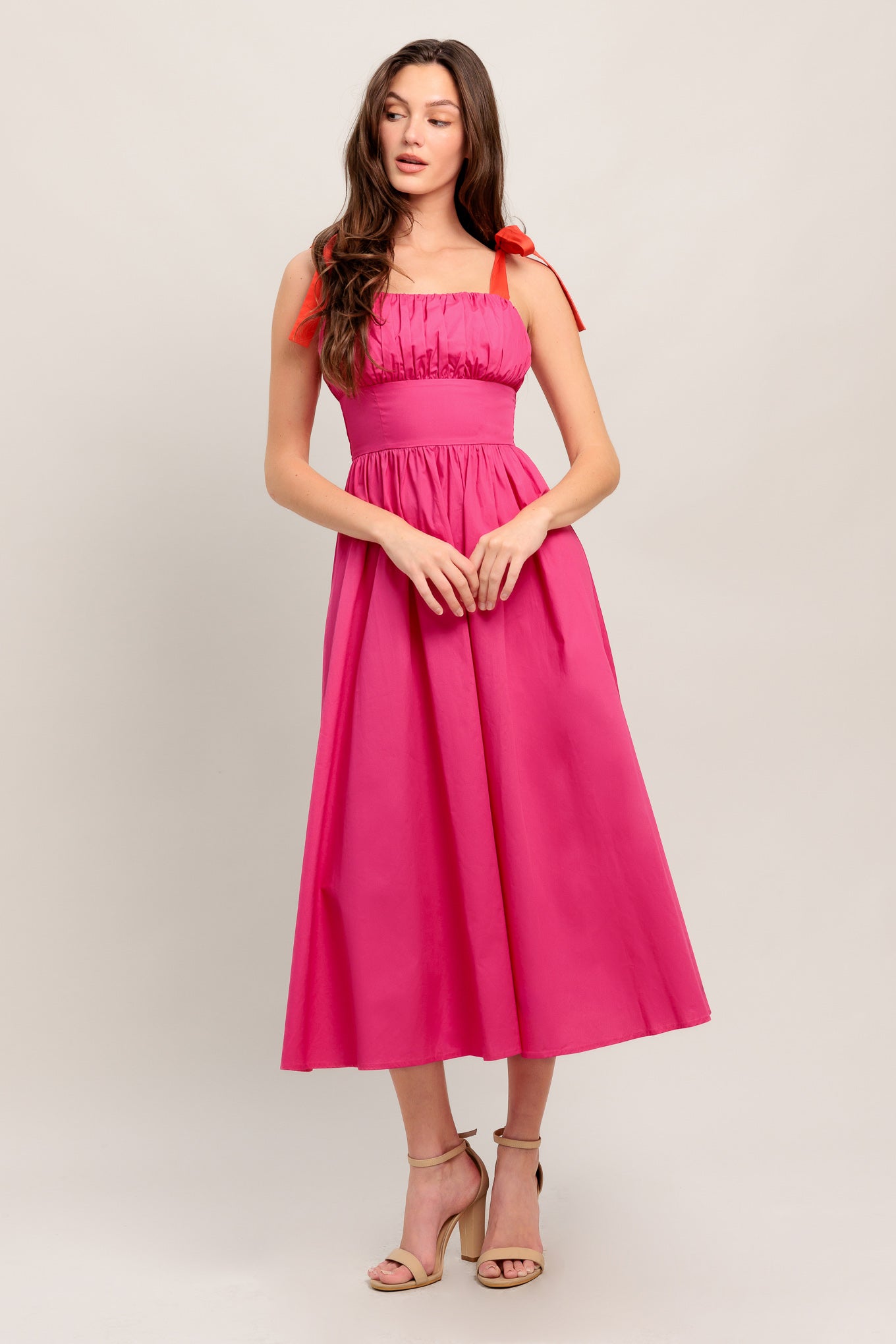 A solid fuchsia woven midi dress featuring straight neckline, red self-tie straps, shirred bodice, full skirt and smocked back bodice and zipper closure

Details:

Self : 100% Cotton
Contrast : 100% Cotton
Lining : 100% Cotton

Size &amp; Fit

- Model is 5`8" And Wearing Size Small
- Measurements Taken From Size Small
- Approx. Length: 51"