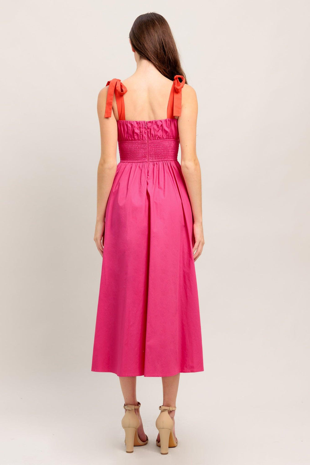 A solid fuchsia woven midi dress featuring straight neckline, red self-tie straps, shirred bodice, full skirt and smocked back bodice and zipper closure

Details:

Self : 100% Cotton
Contrast : 100% Cotton
Lining : 100% Cotton

Size &amp; Fit

- Model is 5`8" And Wearing Size Small
- Measurements Taken From Size Small
- Approx. Length: 51"