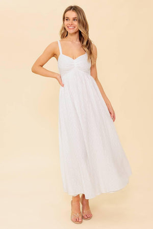 A solid white eyelet midi dress featuring sweetheart neckline, straps, full skirt and smocked back bodice