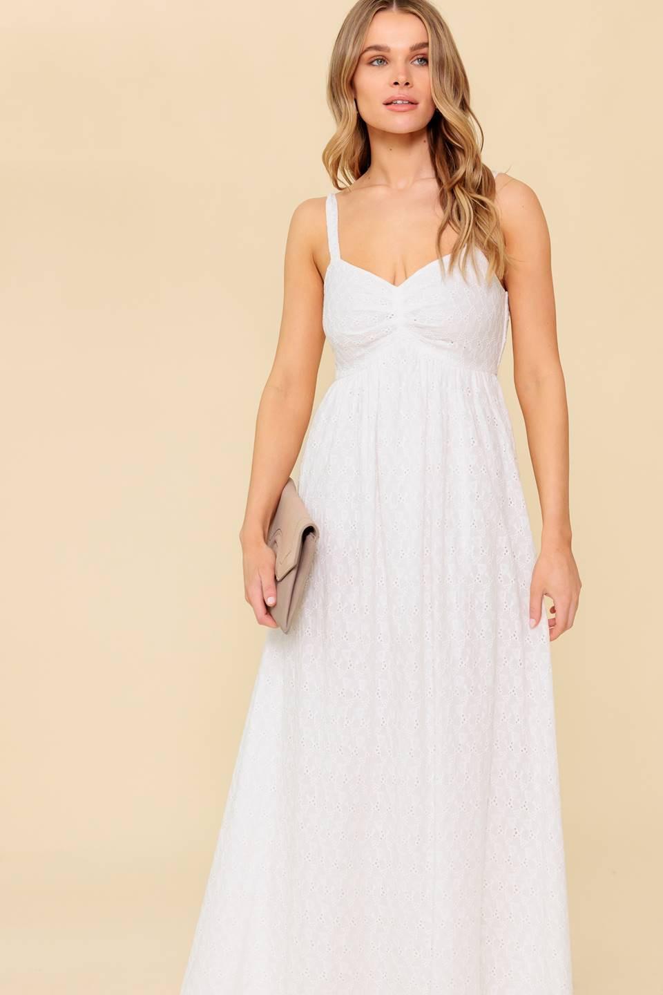 A solid white eyelet midi dress featuring sweetheart neckline, straps, full skirt and smocked back bodice