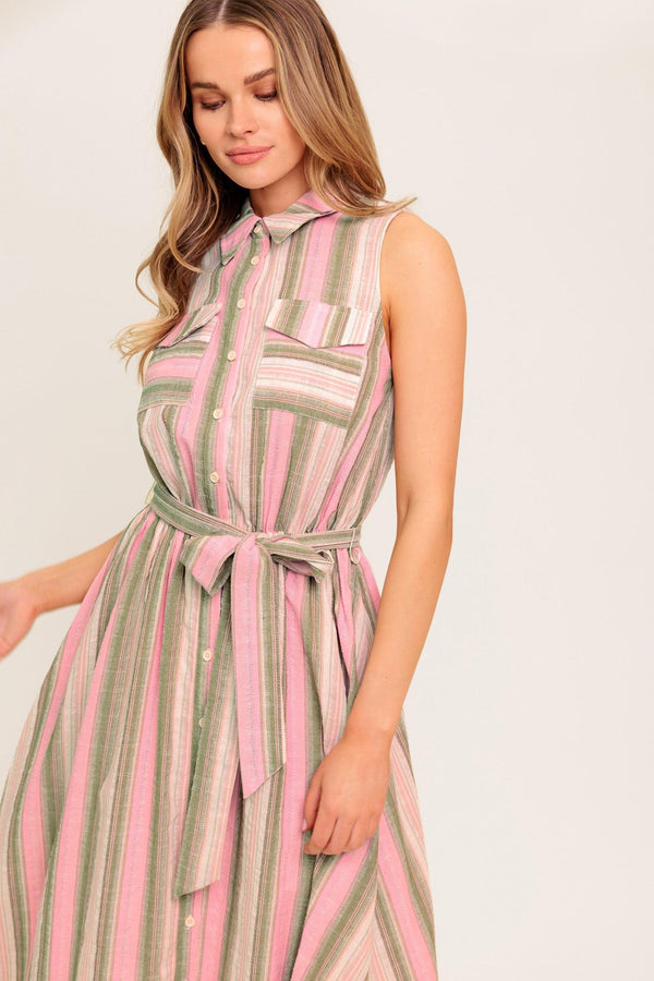 A striped woven midi dress featuring collar, button down, pockets, elasticized waist, self sash and full skirt.
