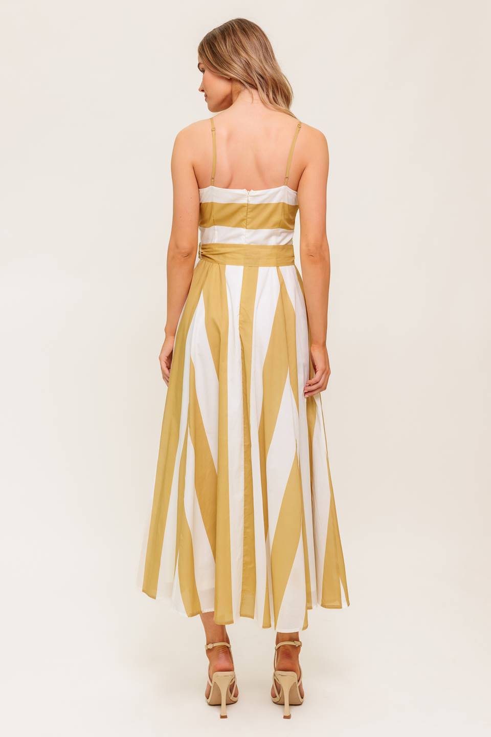A printed woven midi dress featuring straight neckline, straps, self sash tie, circle skirt and back zipper closure.