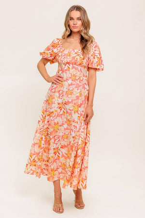A printed woven midi dress featuring square neckline, short puff sleeve, shirred bodice, circle skirt and back zipper closure