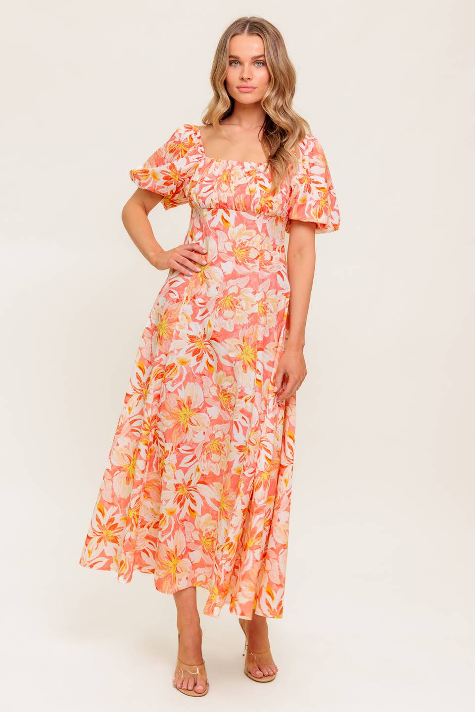 A printed woven midi dress featuring square neckline, short puff sleeve, shirred bodice, circle skirt and back zipper closure