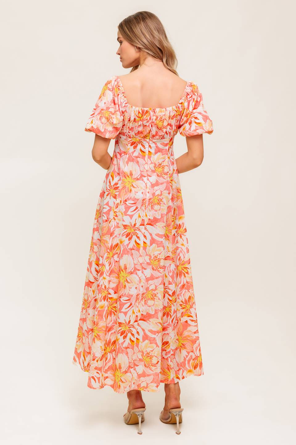 A printed woven midi dress featuring square neckline, short puff sleeve, shirred bodice, circle skirt and back zipper closure