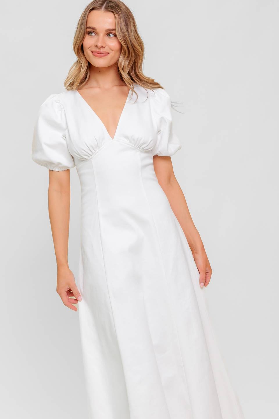 A printed woven midi dress featuring strapless, shirred bodice, full skirt and smock and zipper back closure.