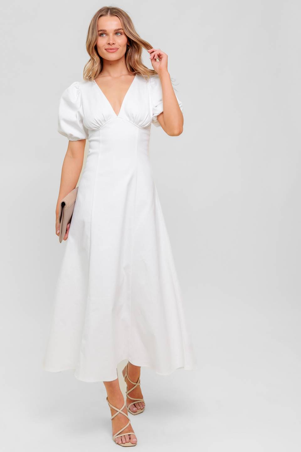 A printed woven midi dress featuring strapless, shirred bodice, full skirt and smock and zipper back closure.