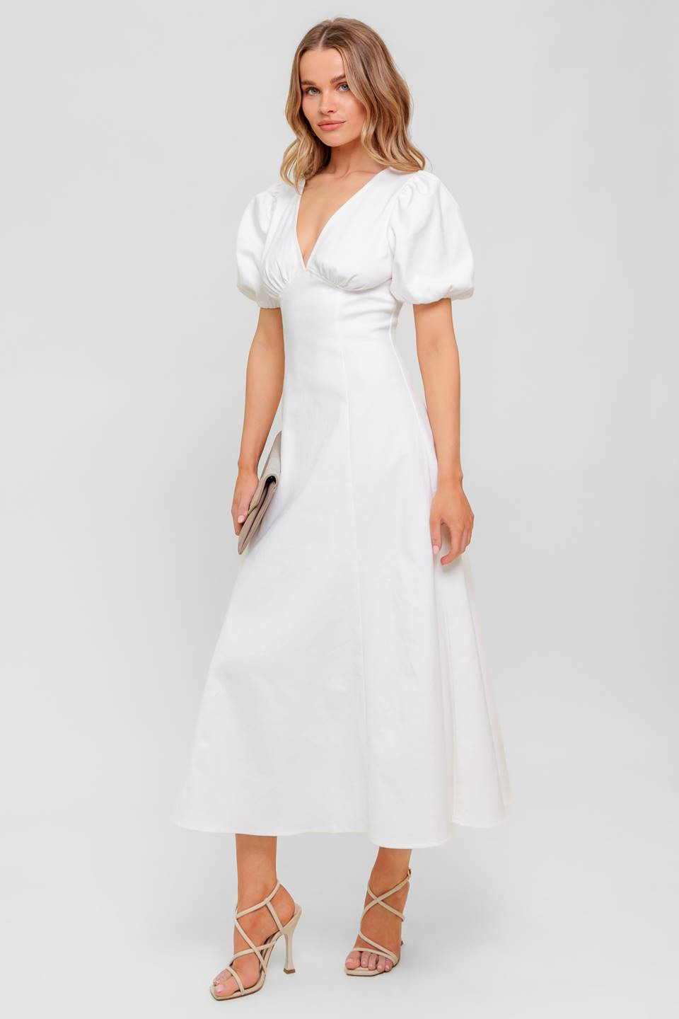 A printed woven midi dress featuring strapless, shirred bodice, full skirt and smock and zipper back closure.