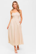 A solid woven midi dress featuring sweetheart neckline, straps, shirred &nbsp;bodice, elasticized back, side pocket and full skirt.