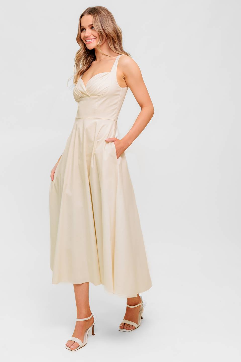 A printed woven midi dress featuring strapless, shirred bodice, full skirt and smock and zipper back closure.