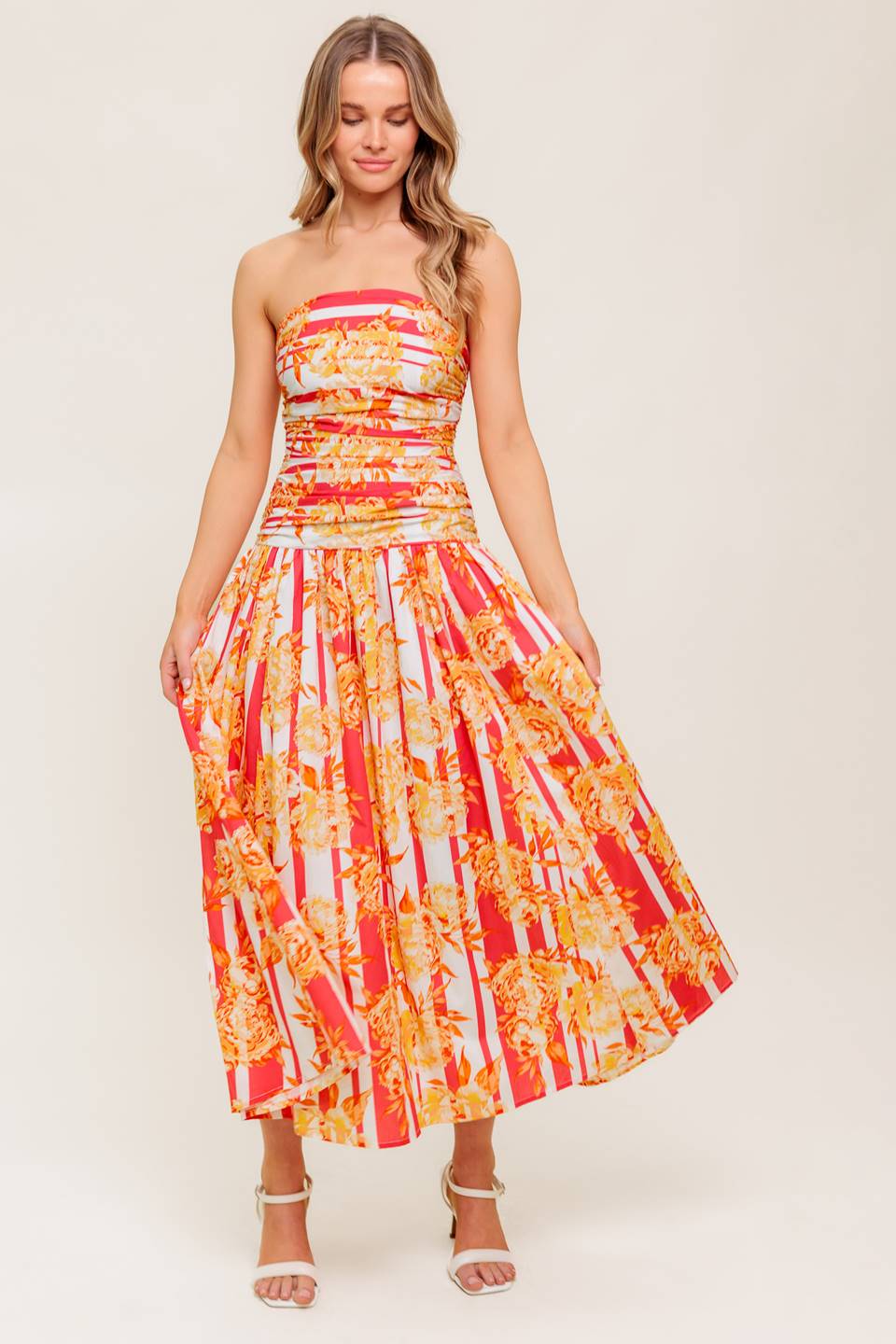 A printed woven midi dress featuring strapless, shirred bodice, full skirt and smock and zipper back closure