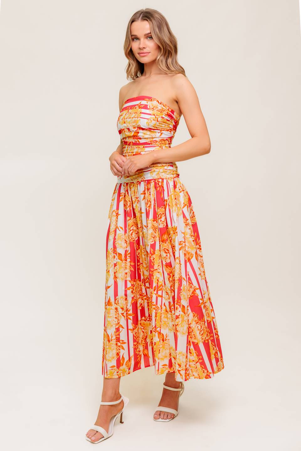 A printed woven midi dress featuring strapless, shirred bodice, full skirt and smock and zipper back closure