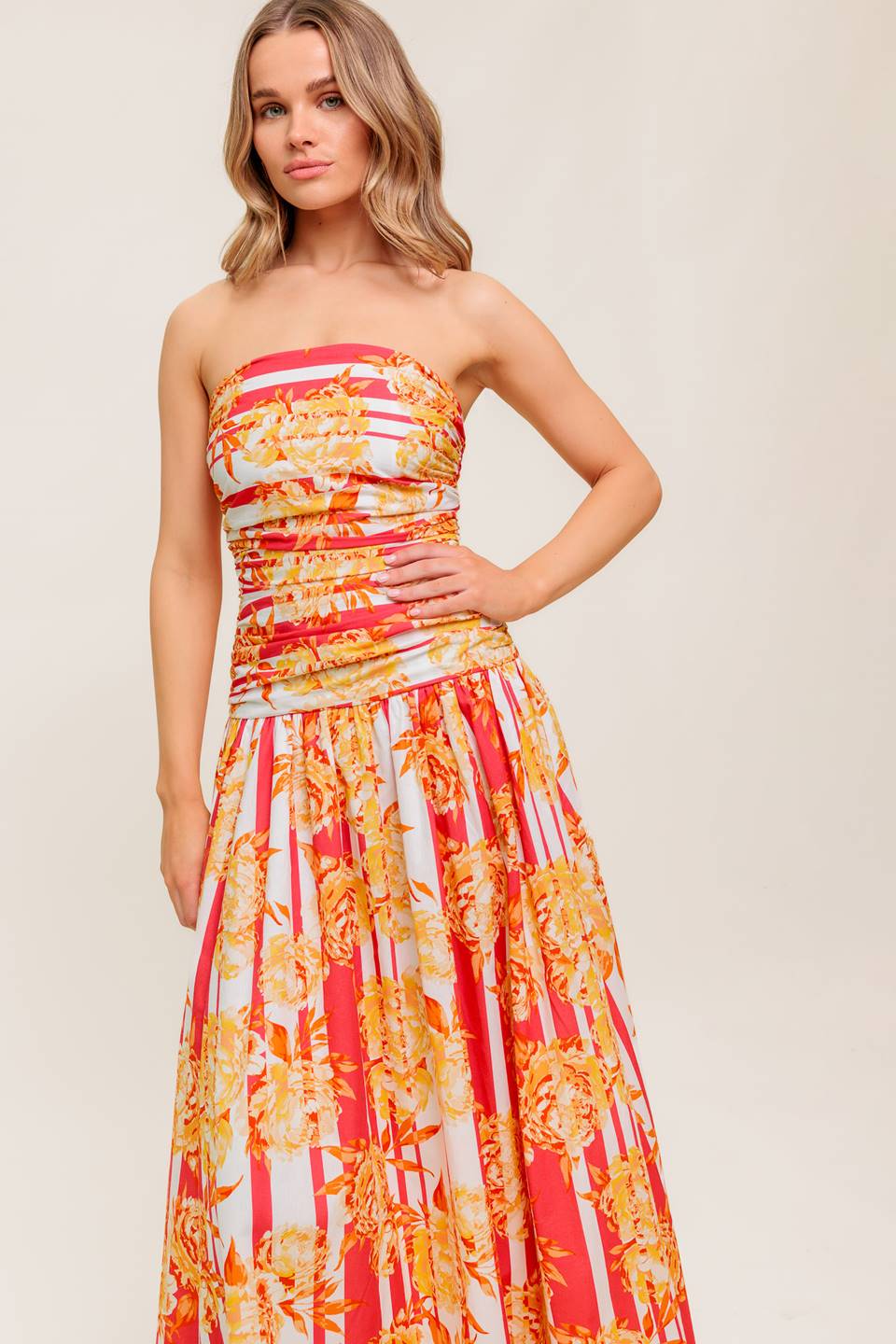 A printed woven midi dress featuring strapless, shirred bodice, full skirt and smock and zipper back closure