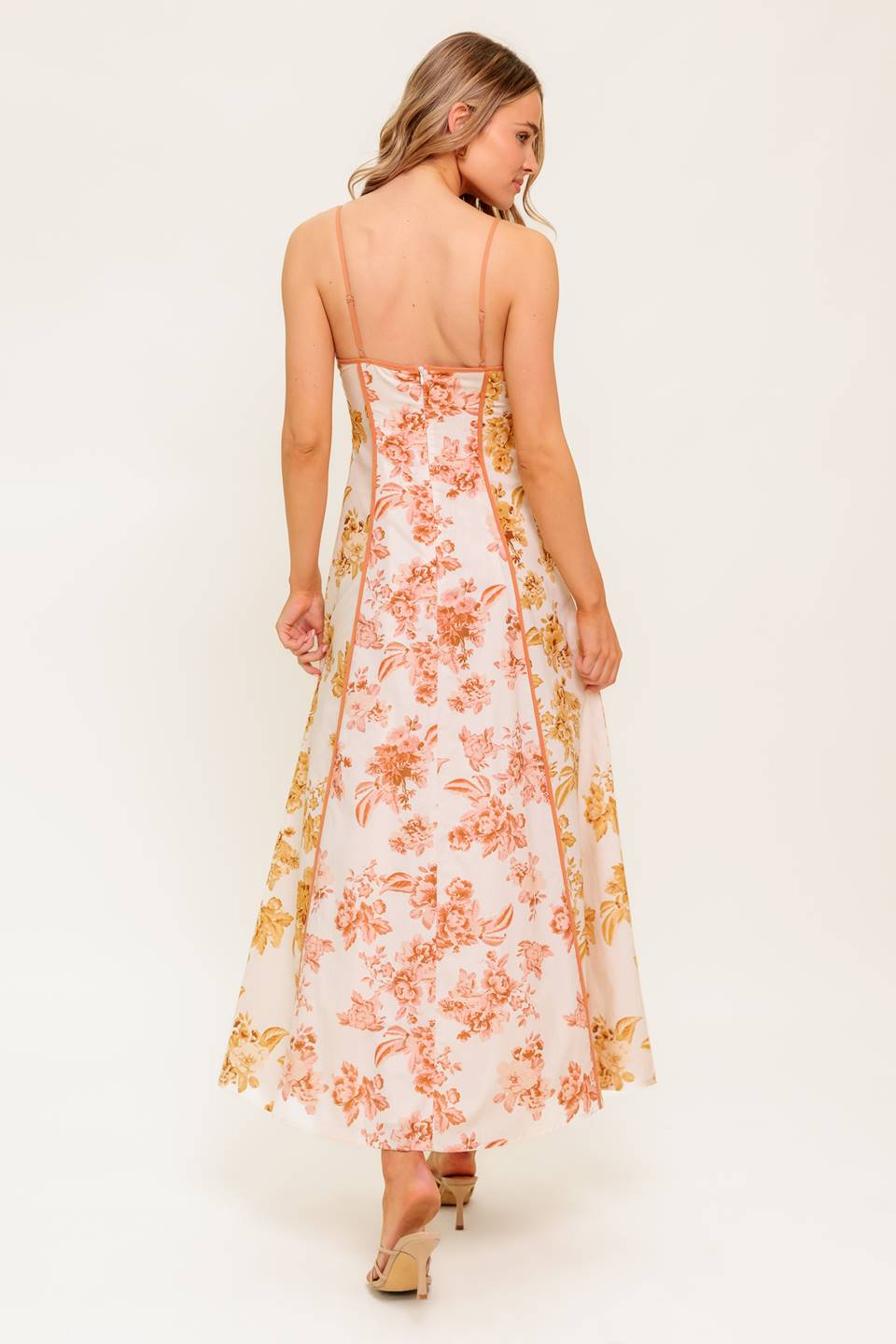 A floral printed woven midi dress featuring cami top, circle skirt and back zipper closure.