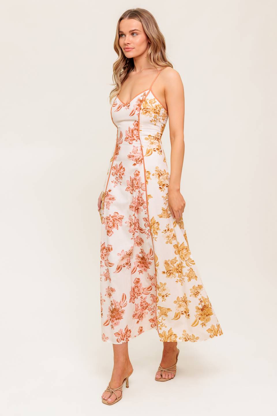 A floral printed woven midi dress featuring cami top, circle skirt and back zipper closure.