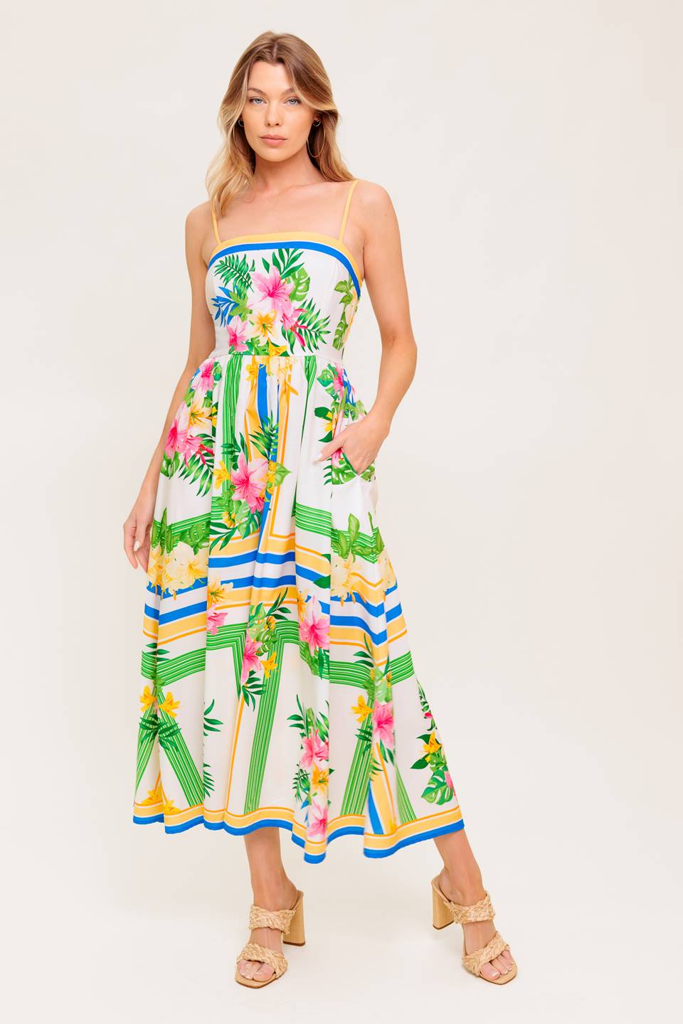A printed woven midi dress featuring straight neckline, straps, full skirt and smocked back bodice.