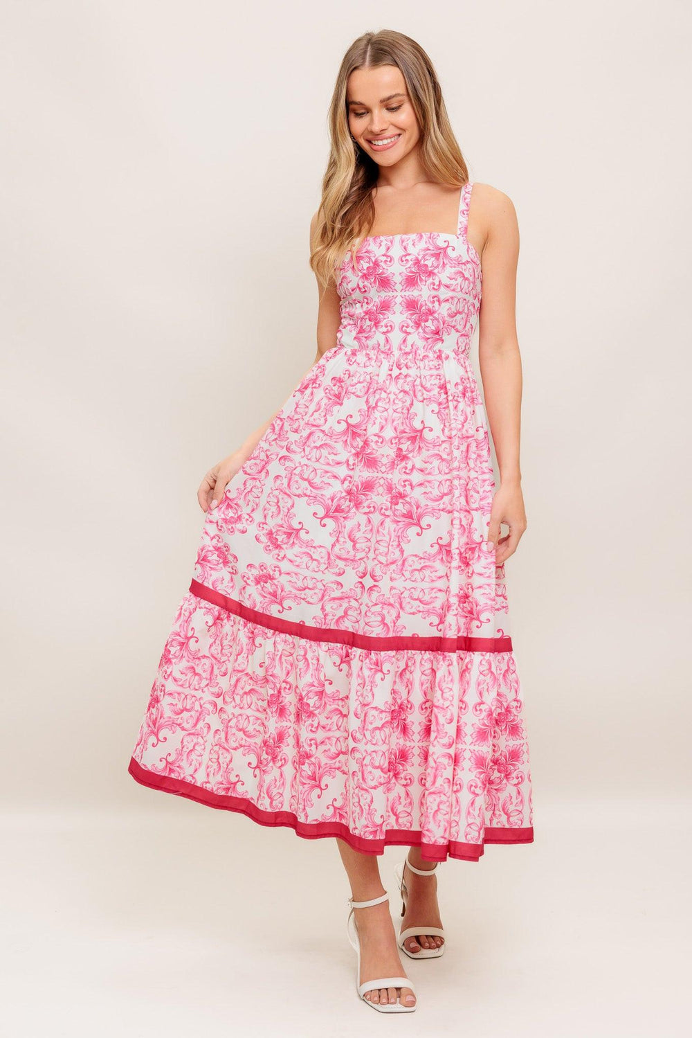 A printed woven midi dress featuring straight neckline, straps, ruffle hemline and smocked back bodice