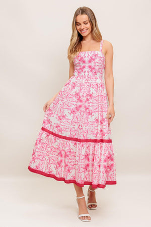 A printed woven midi dress featuring straight neckline, straps, ruffle hemline and smocked back bodice