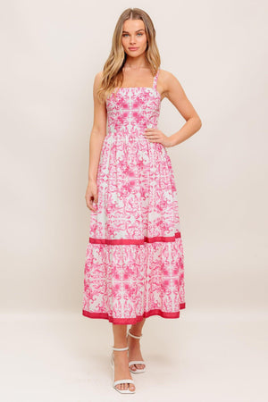 A printed woven midi dress featuring straight neckline, straps, ruffle hemline and smocked back bodice