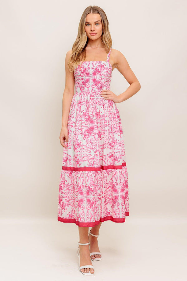 A printed woven midi dress featuring straight neckline, straps, ruffle hemline and smocked back bodice