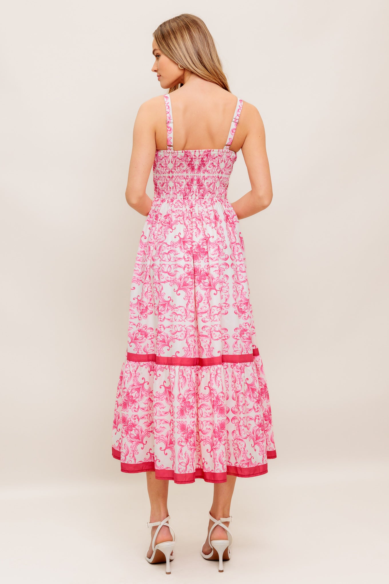 A printed woven midi dress featuring straight neckline, straps, ruffle hemline and smocked back bodice