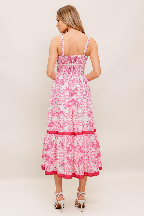 A printed woven midi dress featuring straight neckline, straps, ruffle hemline and smocked back bodice