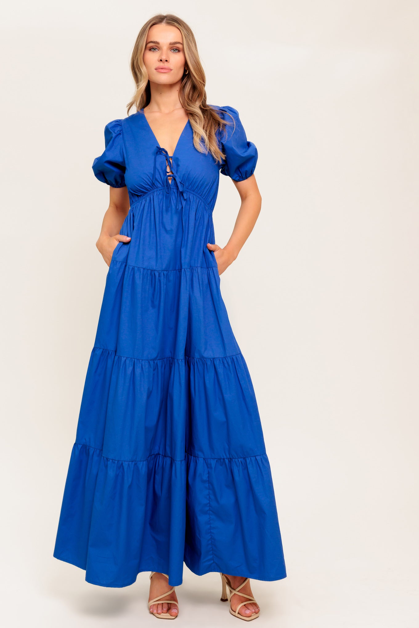 A solid royal blue woven maxi dress featuring V neckline with front bow closure, short puff sleeve, elasticized empire and tiered skirt.

Details:

Self : 100% Cotton

Size &amp; Fit

- Model is 5`8" And Wearing Size Small
- Measurements Taken From Size Small
- Approx. Length: 59" Flying Tomato