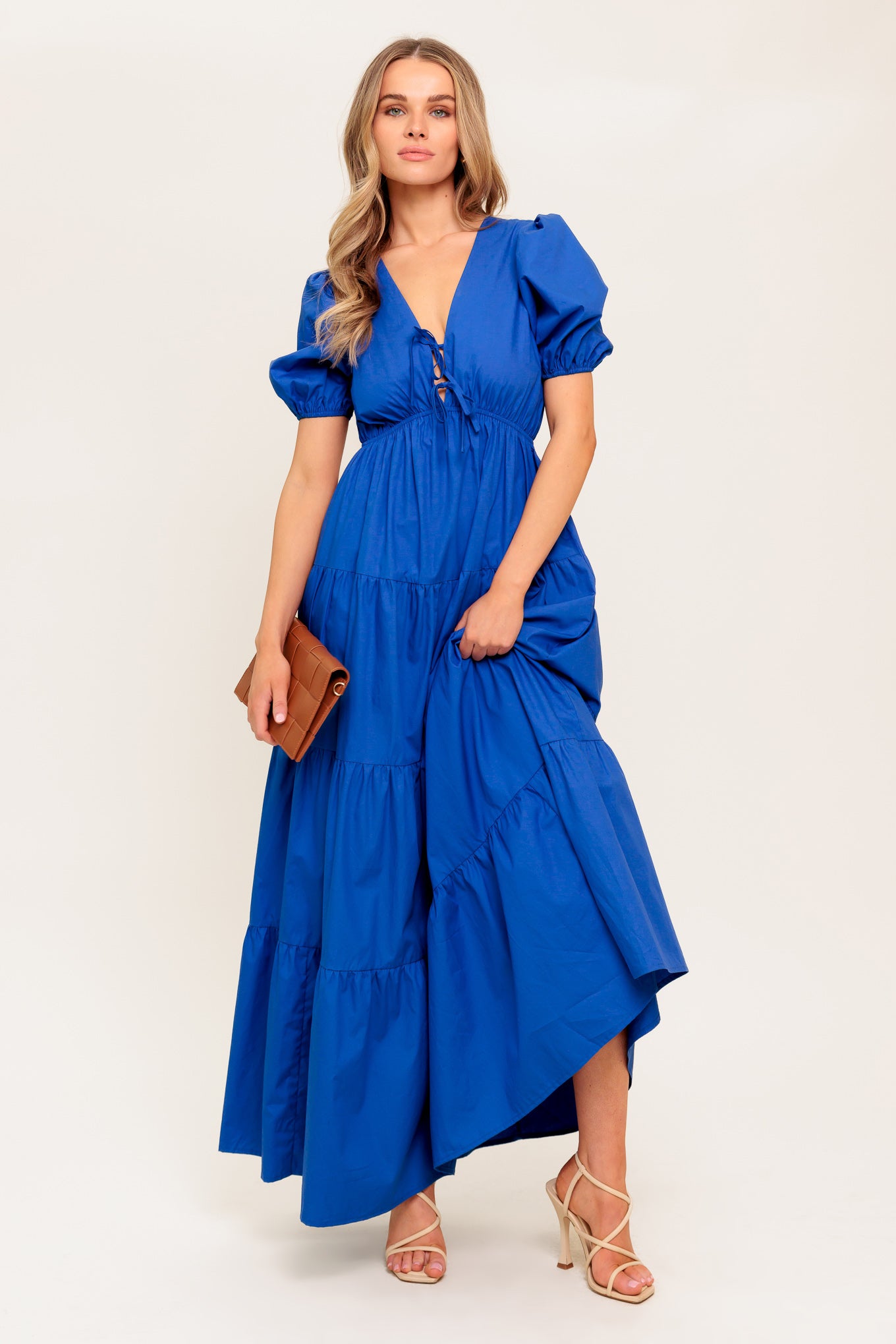 A solid royal blue woven maxi dress featuring V neckline with front bow closure, short puff sleeve, elasticized empire and tiered skirt.

Details:

Self : 100% Cotton

Size &amp; Fit

- Model is 5`8" And Wearing Size Small
- Measurements Taken From Size Small
- Approx. Length: 59" Flying Tomato