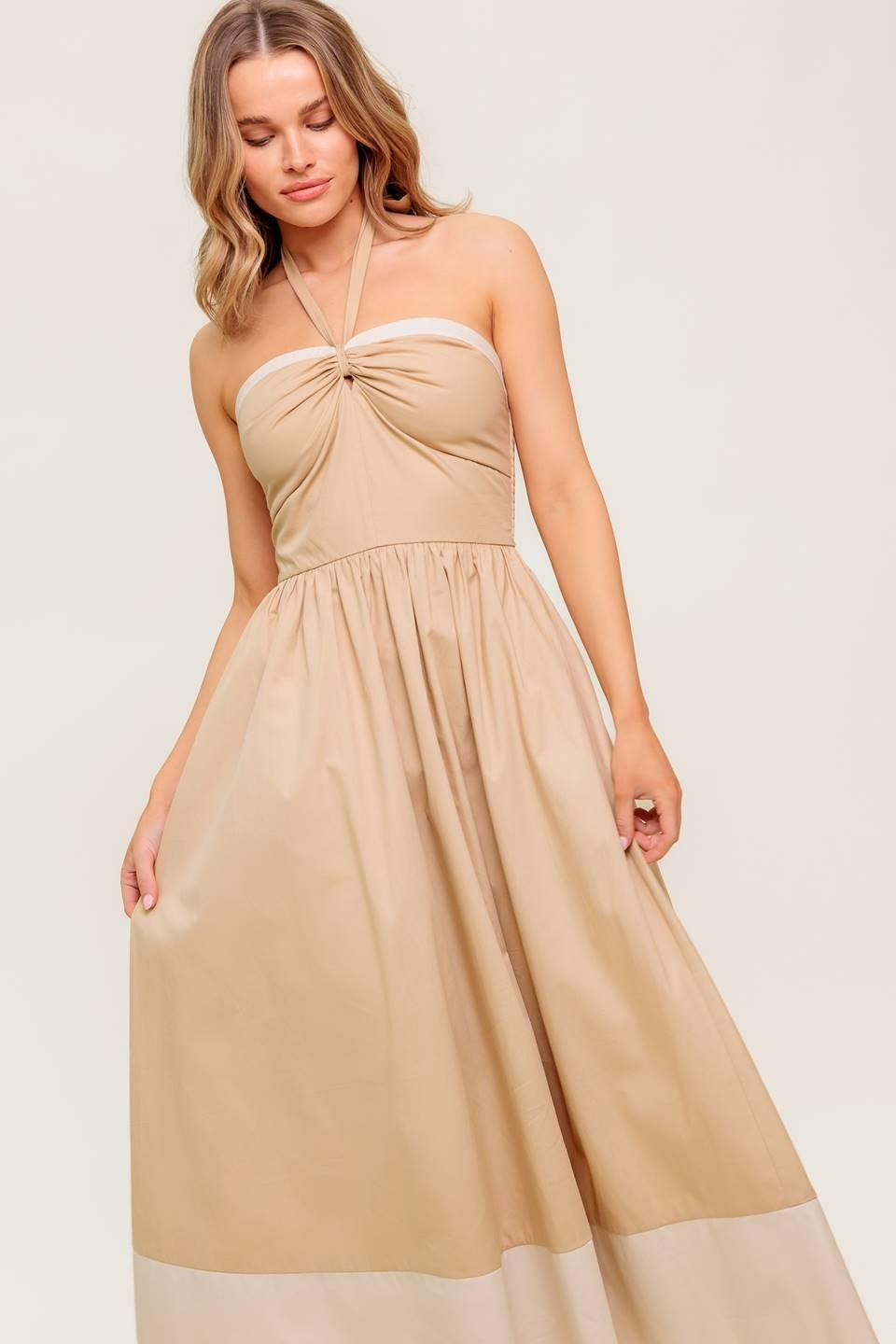 A solid woven midi dress featuring sweetheart neckline with gathered front, halter tie, full skirt and smocked back bodice.