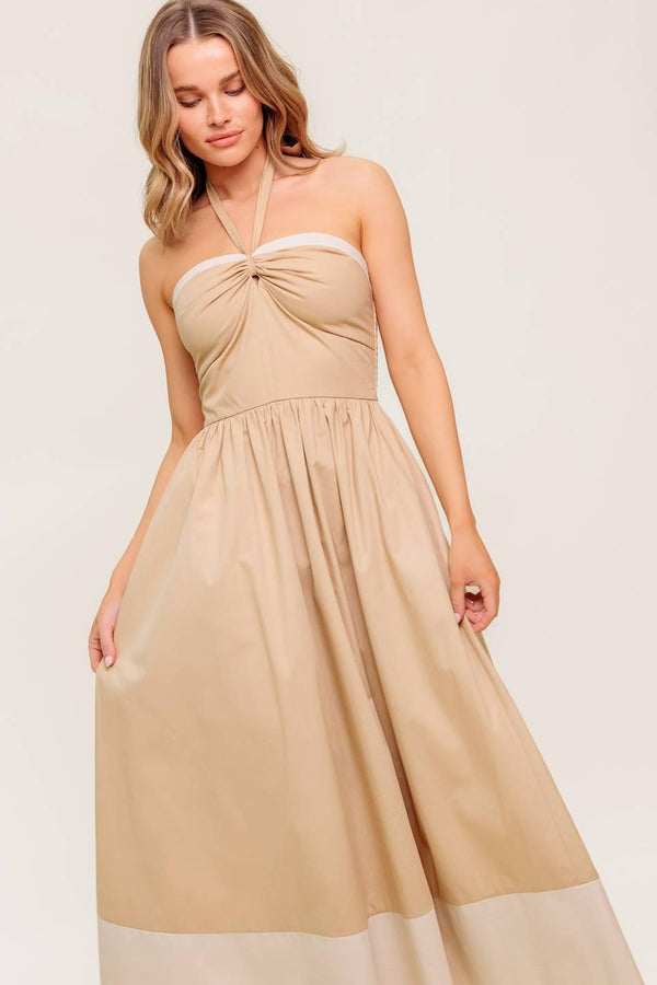 A solid woven midi dress featuring sweetheart neckline with gathered front, halter tie, full skirt and smocked back bodice.