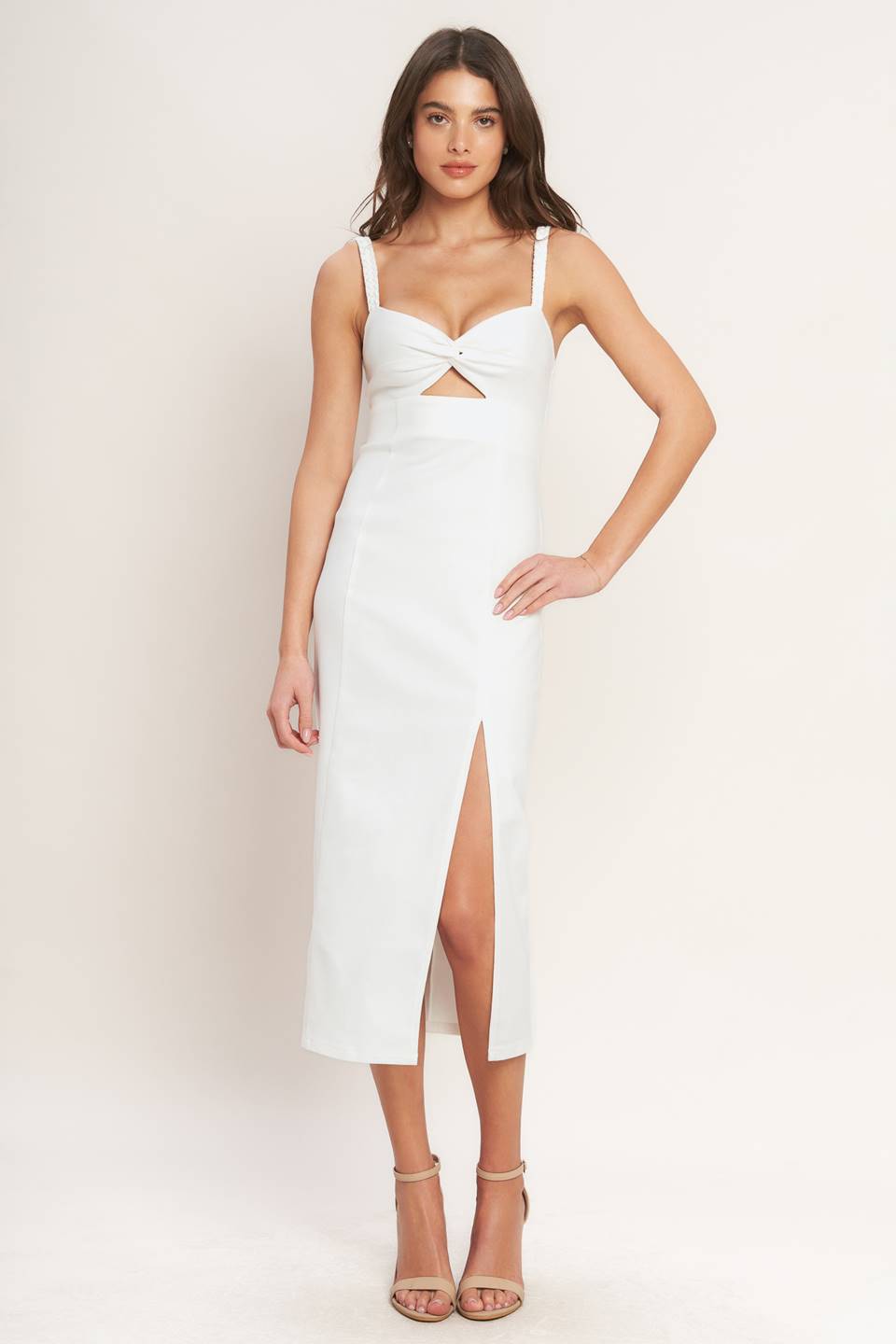 Woman wearing a white dress with a cutout design on a plain background Flying Tomato