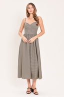 A woman wearing a plaid taupe and brown spaghetti strap midi dress | Flying Tomato
