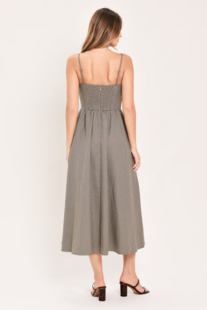 A woman wearing a plaid taupe and brown spaghetti strap midi dress | Flying Tomato