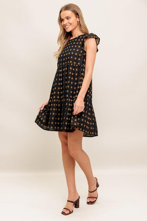 A textured woven mini dress featuring round neckline, ruffled sleeve, tiered body and back neck button closure