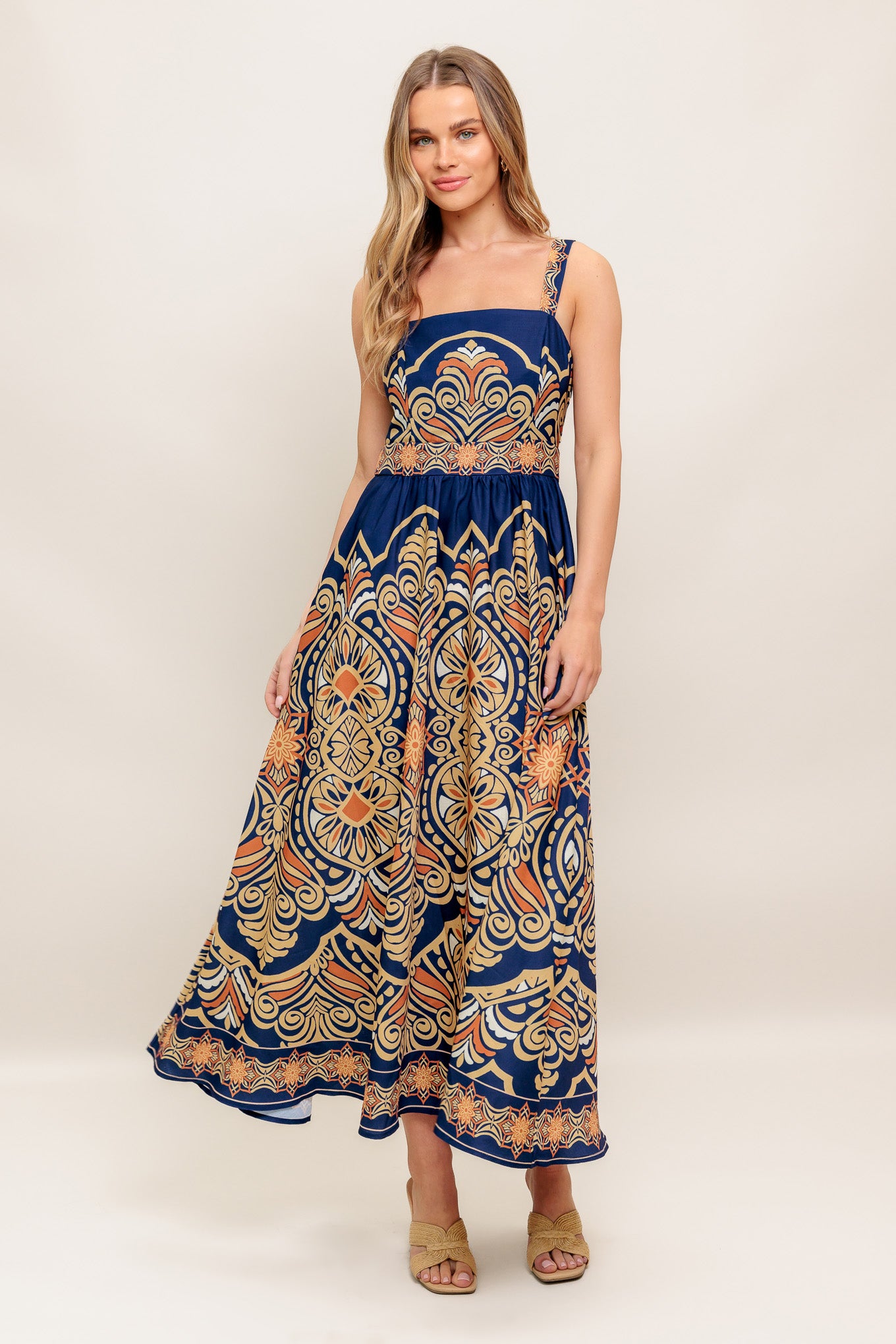 A printed woven midi dress featuring straight neckline, straps, full skirt and back zipper closure
