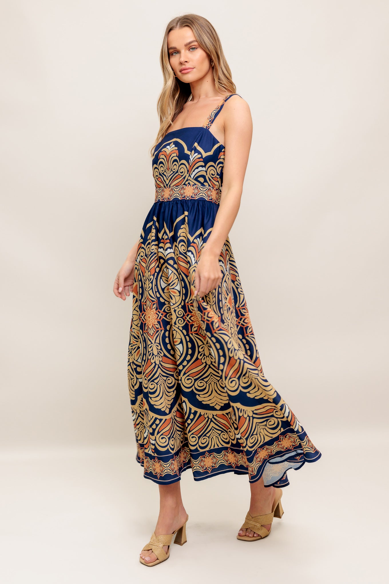 A printed woven midi dress featuring straight neckline, straps, full skirt and back zipper closure