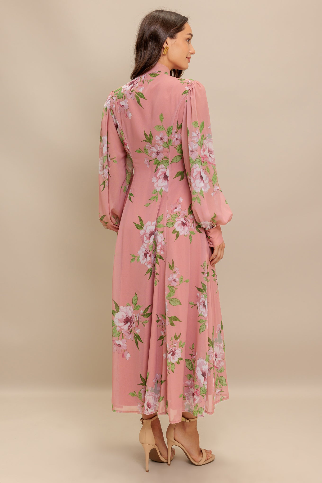 A printed woven midi dress featuring high neckline with bow tie, short puff sleeve with cuff, front button down and circle skirt