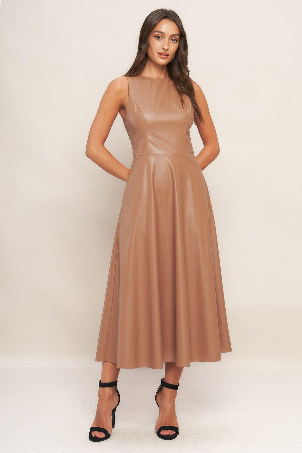 A faux leather midi dress featuring round neckline, sleeveless, circle skirt and back zipper closure