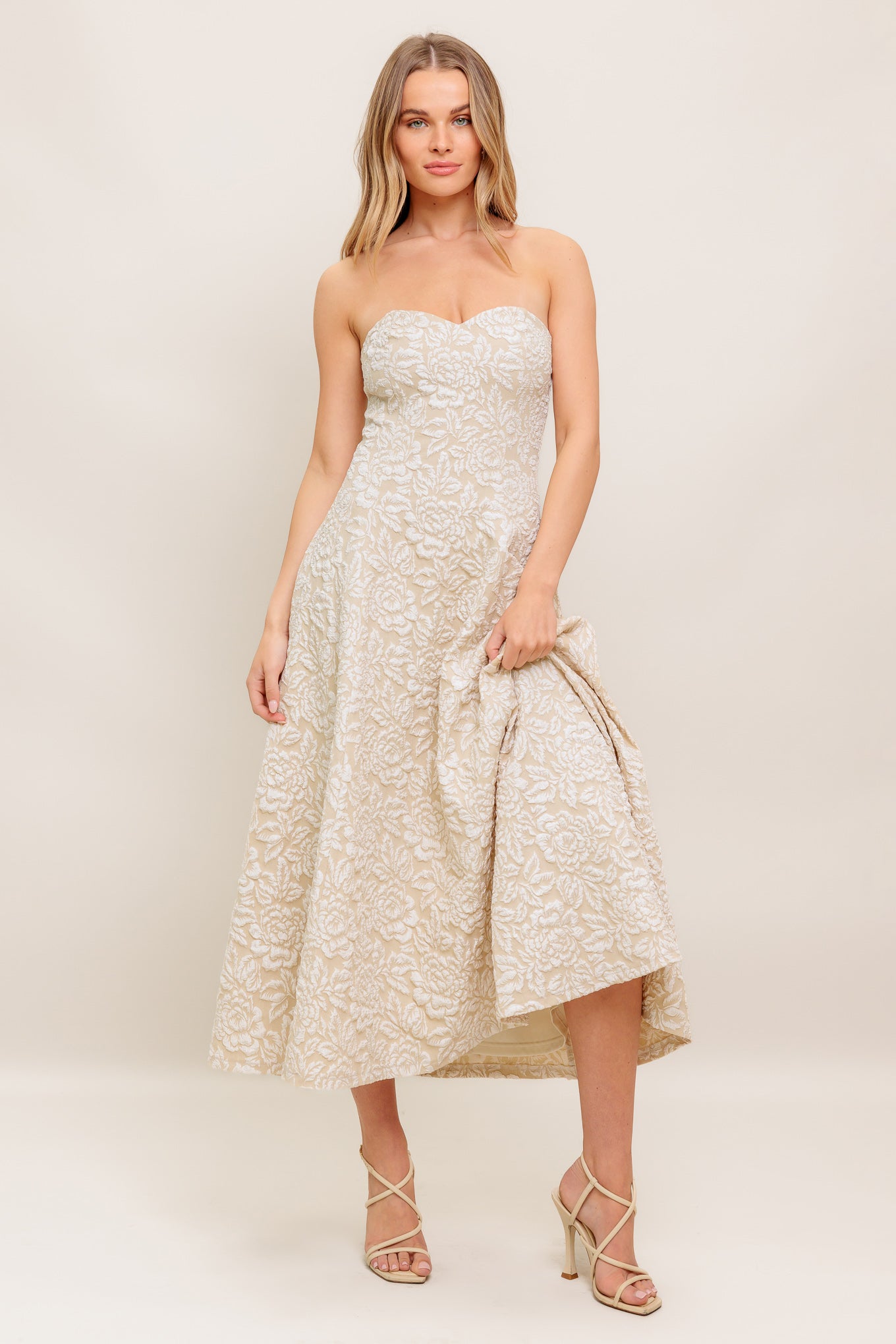 A textured woven midi dress featuring strapless sweetheart neckline, circle skirt and back zipper closure